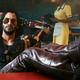 Cyberpunk 2077's Johnny Silverhand sits in a diner, his legs kicked up on the table, chillin.